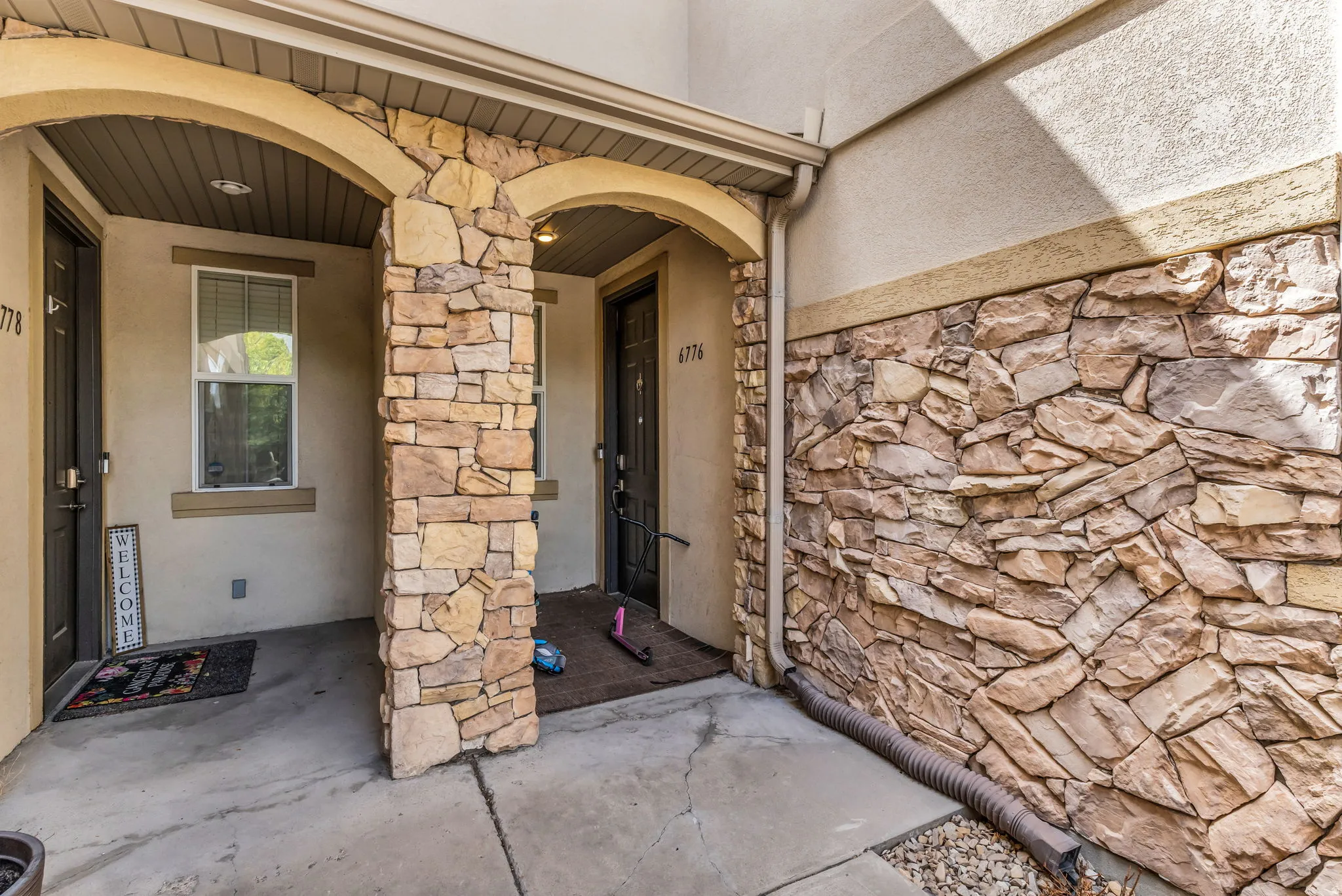 Stone façade detailing an arched entryway