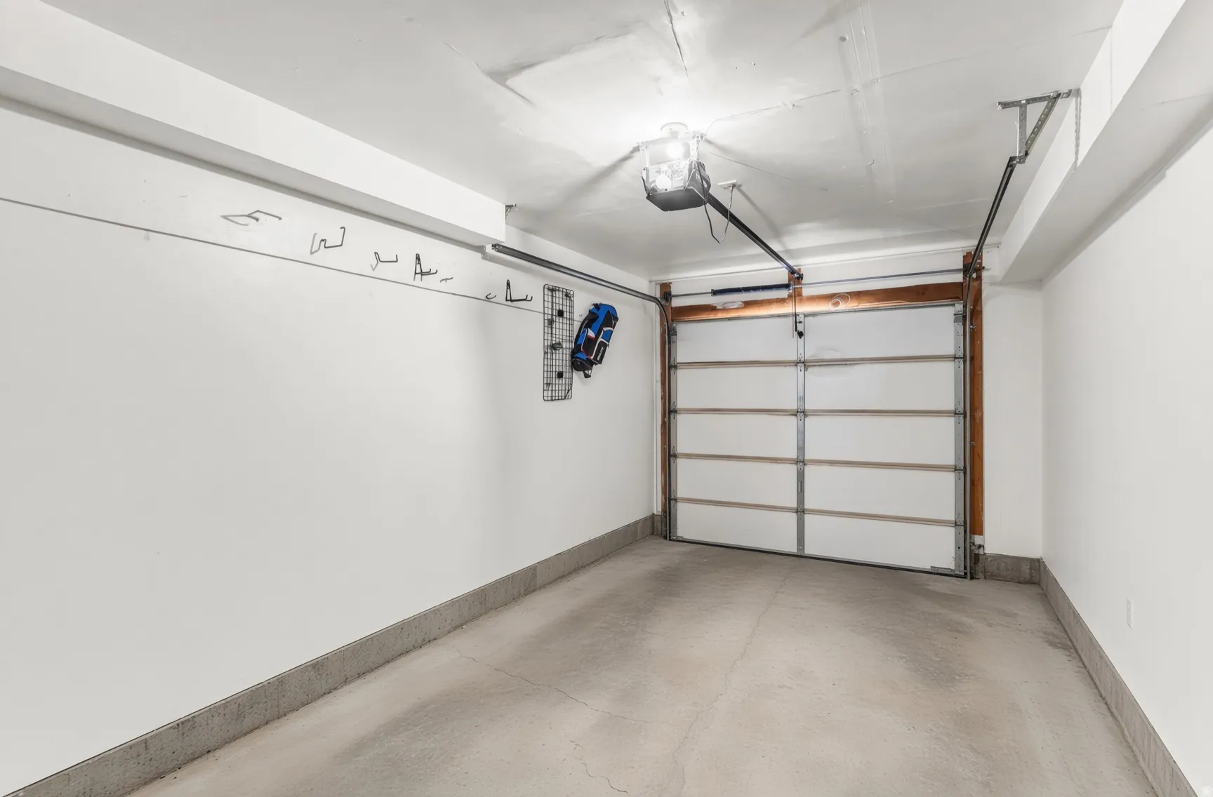Concrete flooring with an automatic overhead garage door and integrated lighting