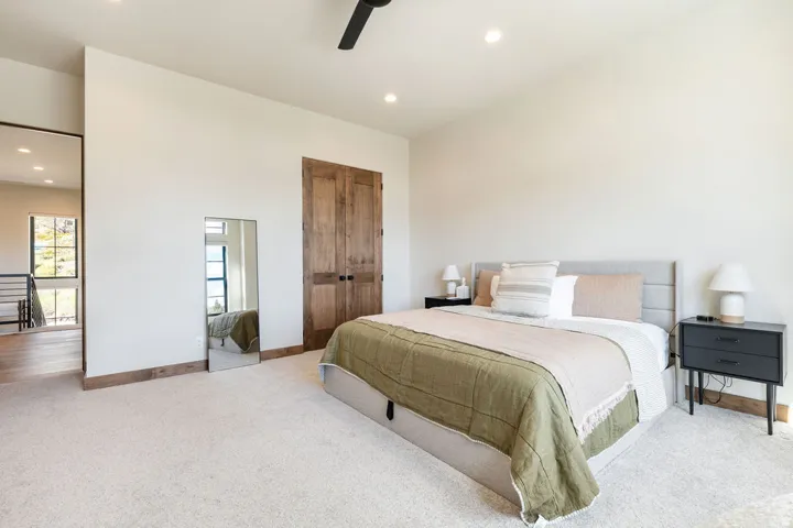 Light-colored carpeting, recessed lighting, ceiling fan, wood-finish doors, and wood-finish trim