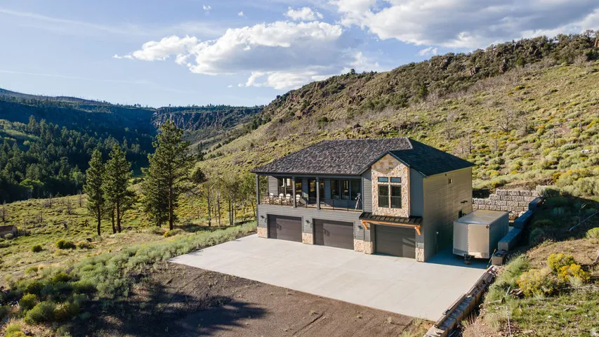 Contemporary home with stone accents and a multi-car garage