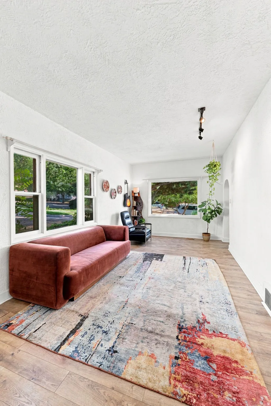 Wood-finish flooring throughout, complemented by a textured white ceiling