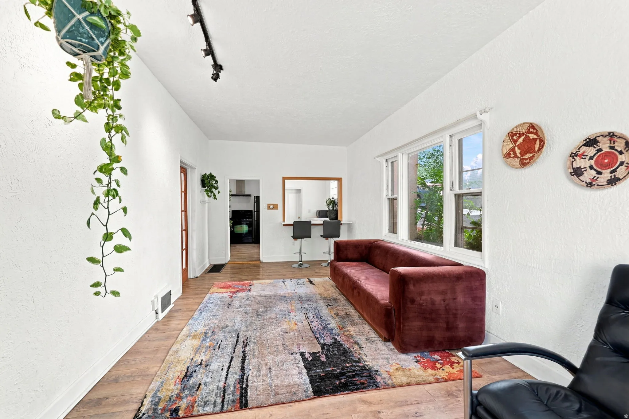 Recessed window offering natural illumination, wood-finish flooring, and a pass-through opening with a built-in counter