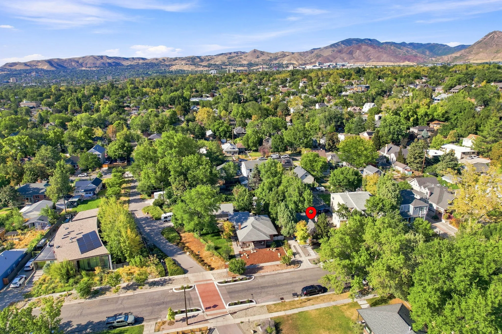 Mature tree-lined neighborhood with mountain backdrop