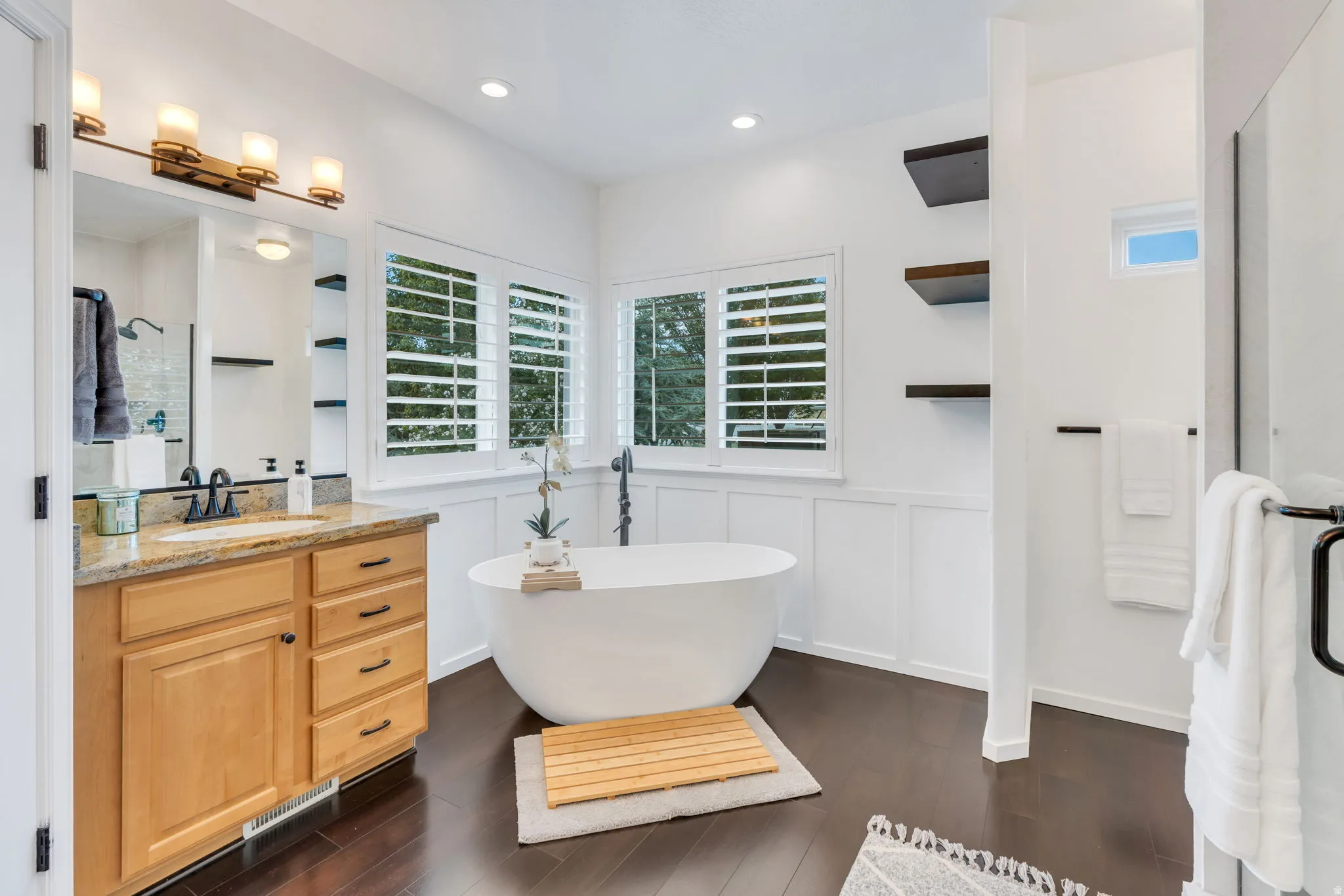 Spa-inspired primary bath featuring a freestanding soaking tub, spacious walk-in shower, dual vanities, and beautiful updated finishes—your own private retreat at the end of the day.
