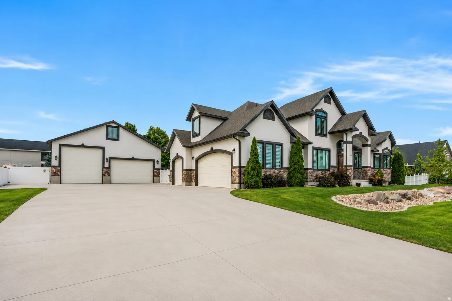 An expansive driveway provides exceptional parking and easy maneuverability for RVs, trailers, trucks and equipment, connecting the 3-car attached garage with the impressive 40' x 40' detached shop.