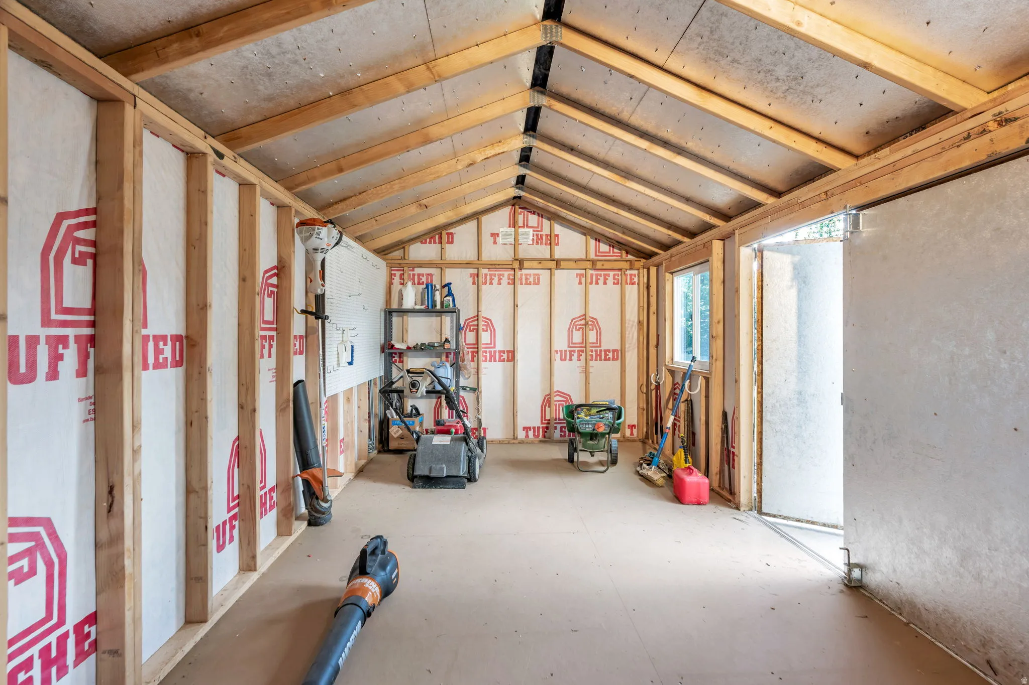 Inside the backyard shed is plenty of clean space to store your yard equipment or toys.
