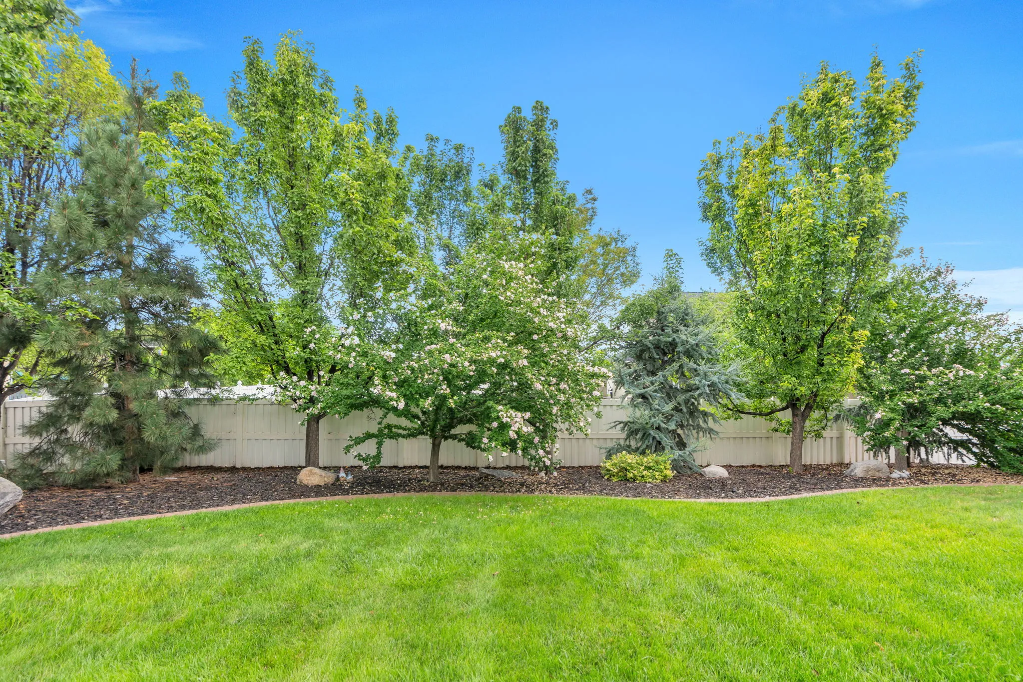 Enjoy your own private oasis, surrounded by mature trees and thoughtfully designed landscaping that has taken years to establish.