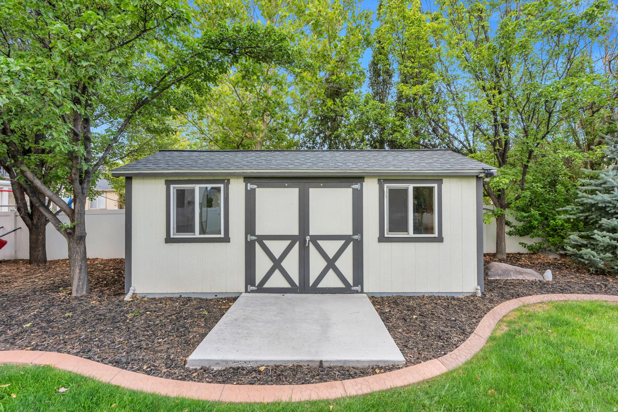 Enjoy a storage shed in the back yard for all your landscaping equipment, designed to match the exterior of the home.