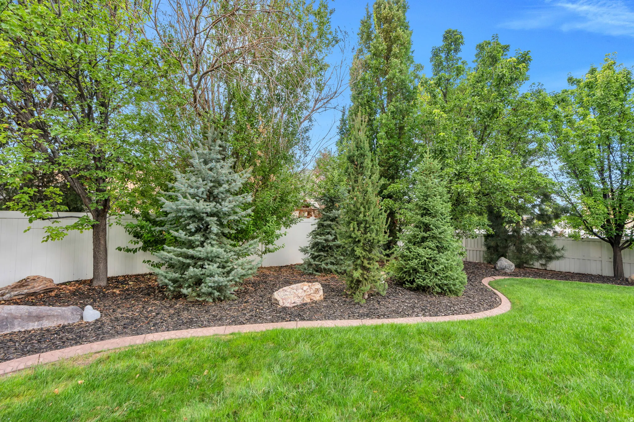 Mature trees and established landscaping create a comfortable and private outdoor setting.