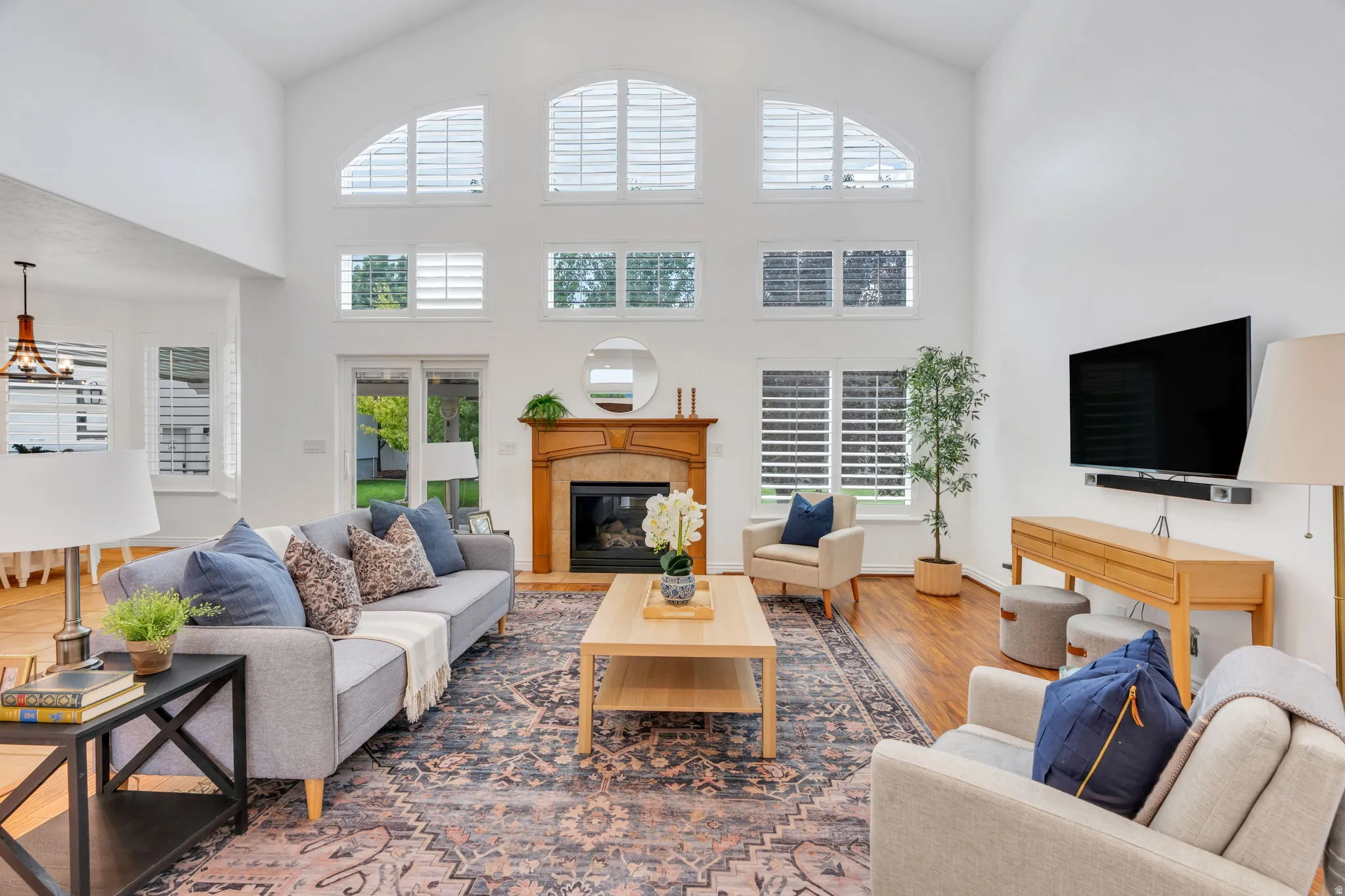 Stunning great room with soaring ceilings, a dramatic wall of windows, and beautiful natural light.