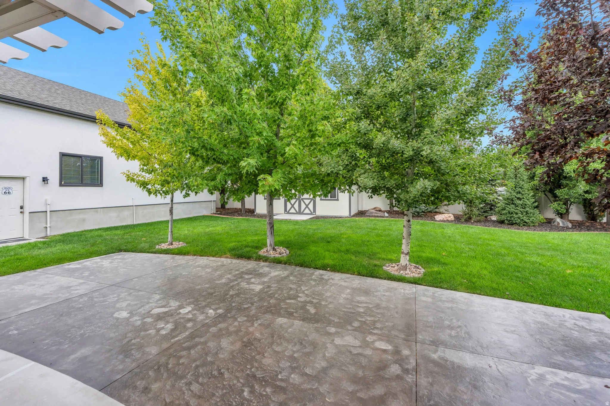 Expansive stamped concrete patio with direct lawn access