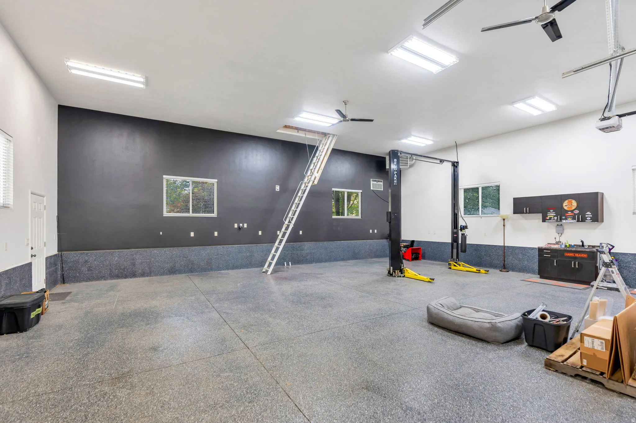 The ultimate 40' x 40' detached garage/shop—1,600 sq. ft. of climate-controlled space featuring a 14' RV door, 10,000-lb car lift, epoxy floors, 220V power, and a large storage loft. A dream setup for car collectors, RV owners, business owners, and seri