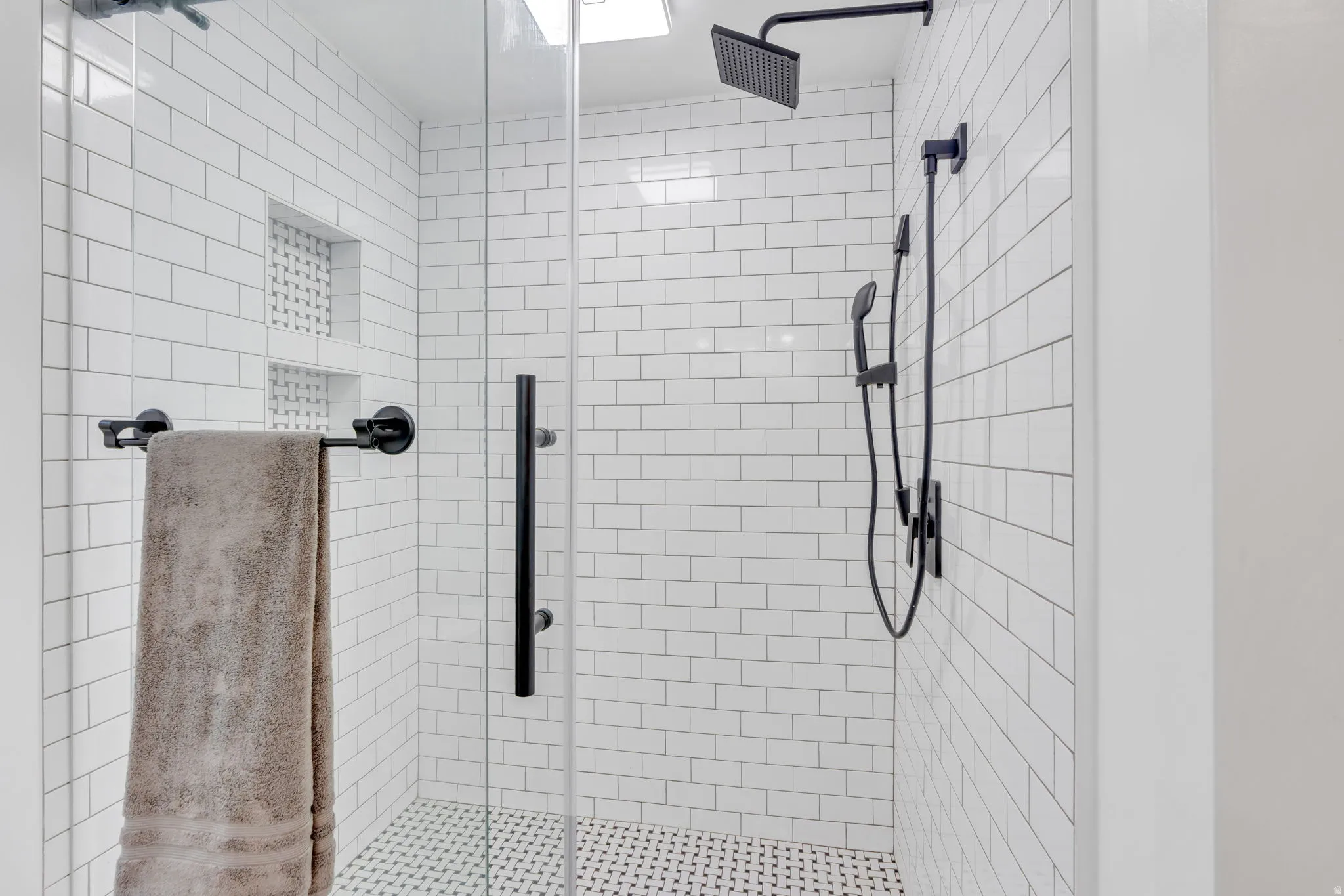 Custom-remodeled basement bath showcases a stunning Euro shower, beautiful tilework, and stylish finishes for a polished, upscale feel.