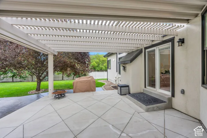 A backyard designed to be enjoyed, with lawn, shade, and abundant patio space.