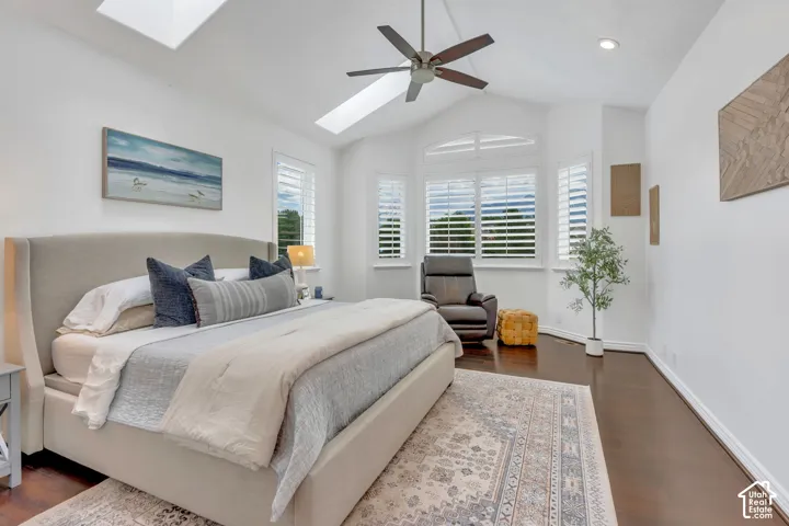 Beautiful primary suite with a vaulted ceiling, skylights, updated floors, and walls of windows with mountain views that fill the room with natural light.