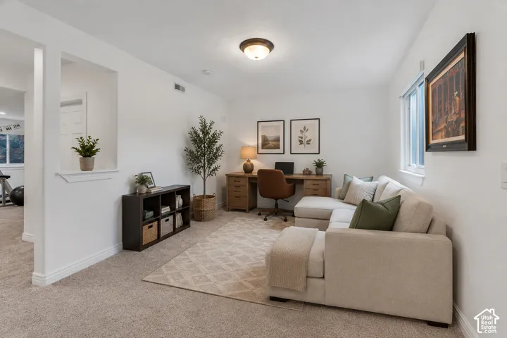 Versatile bonus area in the downstairs could serve beautifully as an office, reading nook, play space, or sitting area. Virtually staged as a sitting area to showcase one of the many possibilities for this flexible space.
