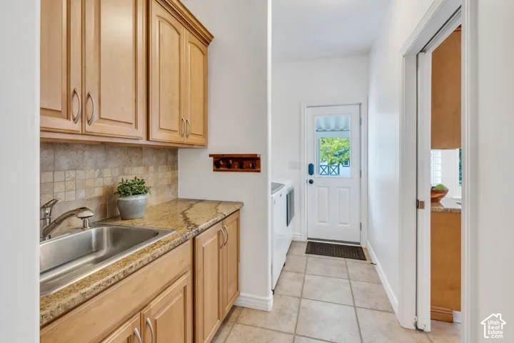Spacious laundry room with a convenient separate entrance providing direct access to the backyard and patio