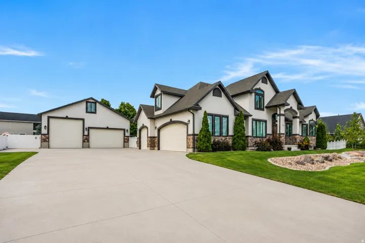 An expansive driveway provides exceptional parking and easy maneuverability for RVs, trailers, trucks and equipment, connecting the 3-car attached garage with the impressive 40' x 40' detached shop.