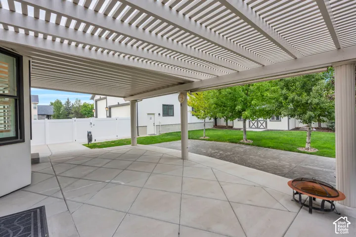 The covered patio provides welcome shade and a natural extension of the home's living space.