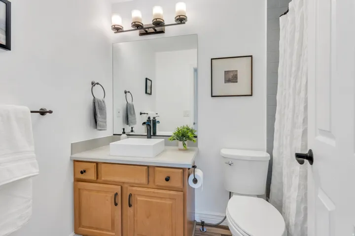 The spacious bedroom above the garage enjoys its own full bathroom, creating a private suite that's ideal for guests, family, or extended stays.