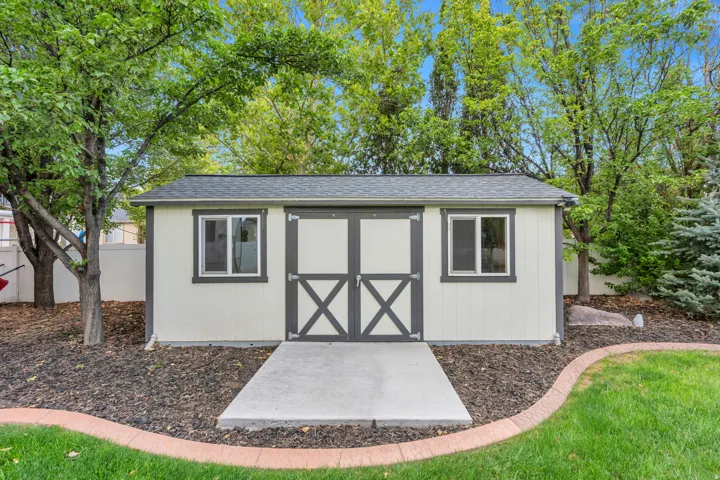 Enjoy a storage shed in the back yard for all your landscaping equipment, designed to match the exterior of the home.