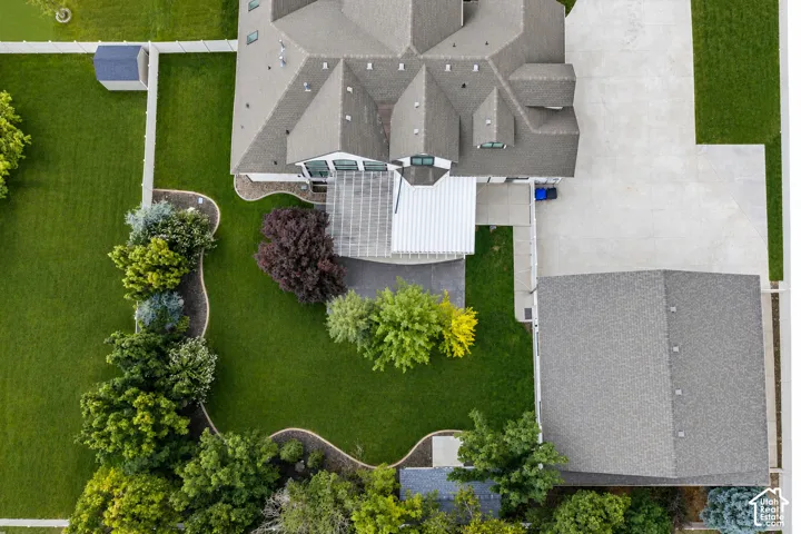 Aerial view highlights the property's spacious grounds, extensive parking, and impressive garage configuration.