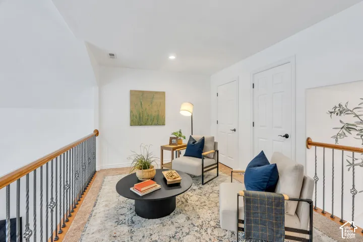 Open upper-level sitting area overlooks the great room below
