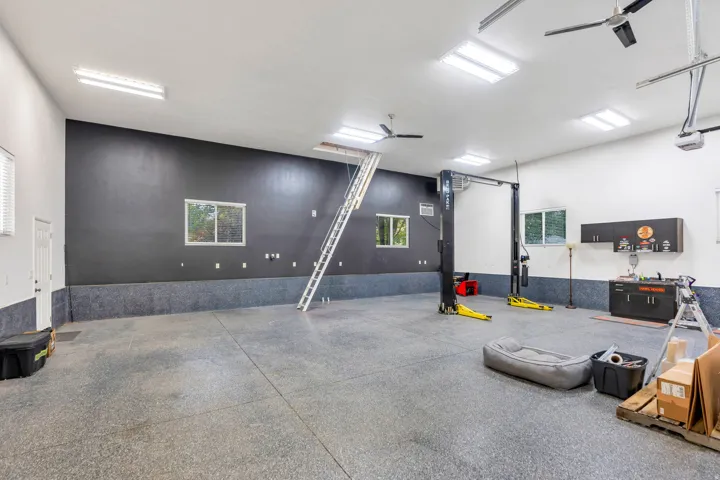 The ultimate 40' x 40' detached garage/shop—1,600 sq. ft. of climate-controlled space featuring a 14' RV door, 10,000-lb car lift, epoxy floors, 220V power, and a large storage loft. A dream setup for car collectors, RV owners, business owners, and seri