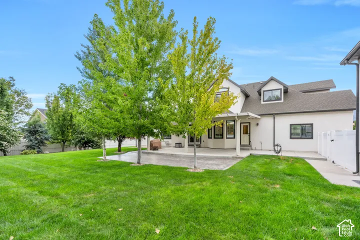 Enjoy summer evenings, outdoor meals, and gatherings in this inviting backyard.