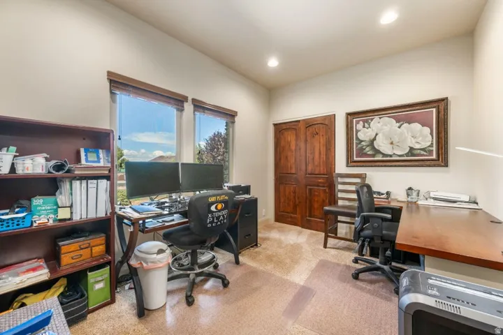 Recessed lighting, wood-finish double doors, and two large windows