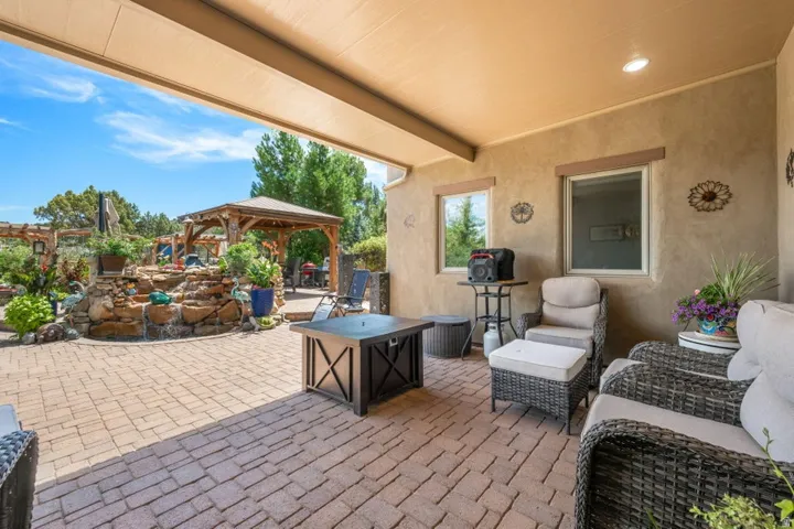 Covered patio with a stucco exterior, recessed lighting, and a paver patio surface