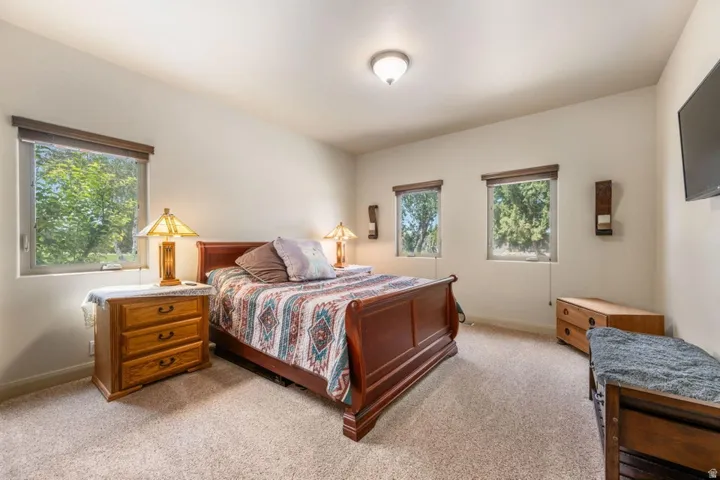 Carpeted flooring, vaulted ceiling, and recessed lighting