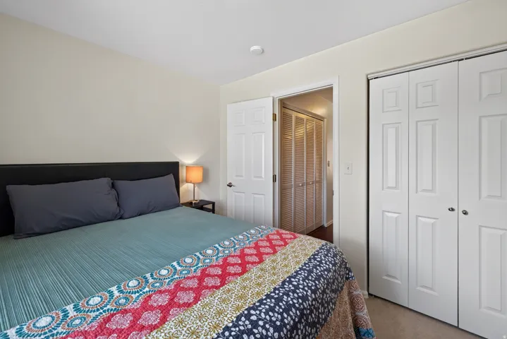 Recessed lighting, light-toned wall paint, hinged interior door, bi-fold closet doors, and carpet flooring
