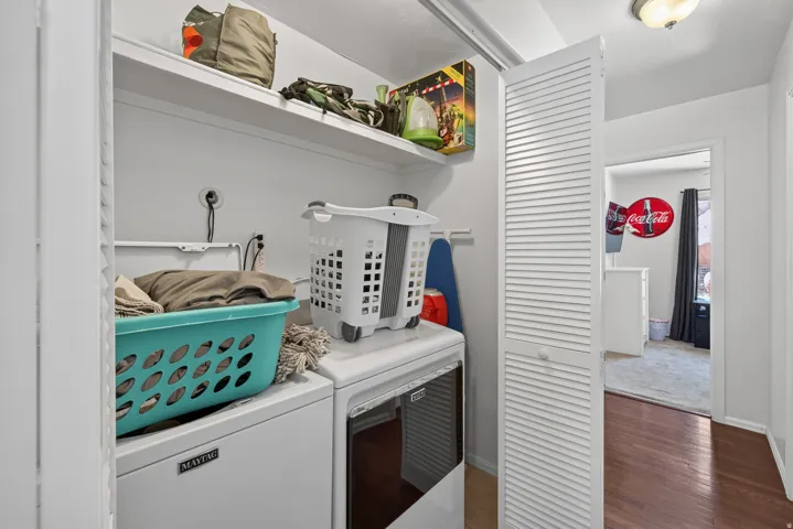 Laundry area with built-in shelving and louvered bifold doors