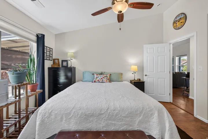 Vaulted ceiling with a ceiling fan, neutral wall tones, and a paneled interior door