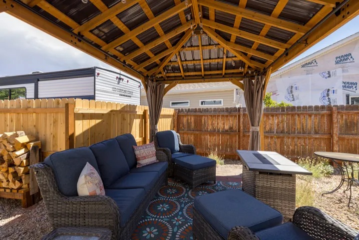 Paved patio area featuring a built-in wooden gazebo with a metal roof