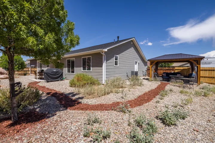 Gray siding exterior with white window trim
