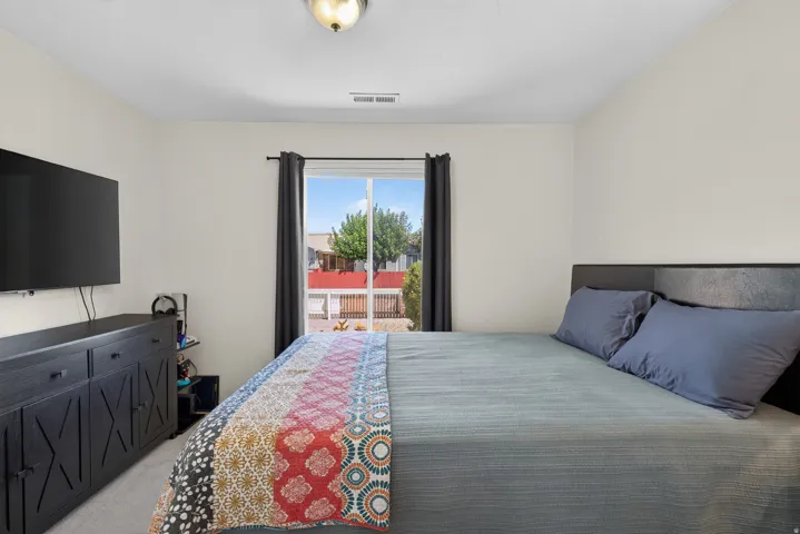 Recessed window with dark curtain rods, light-colored walls, and a mounted light fixture
