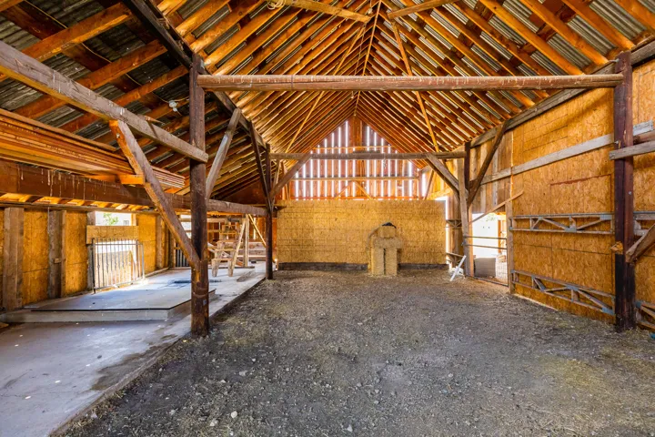 Exposed wood beam construction with a corrugated metal roof