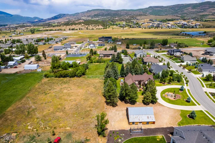 Expansive lot with mountain backdrop, established neighborhood, and paved roads