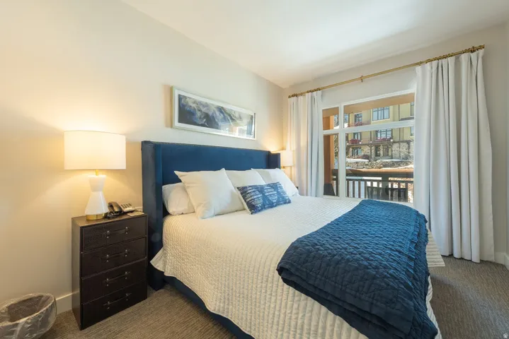 Recessed lighting, wood-finish flooring, full-height window, balcony access, and built-in closet
