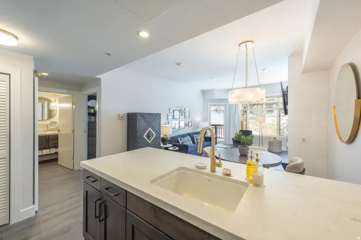 Kitchen island with an undermount sink and gold-finish faucet