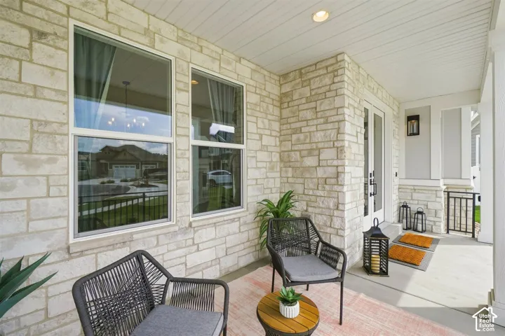 Enjoy this Covered front porch featuring stone veneer, a recessed light, and a double-door entry
