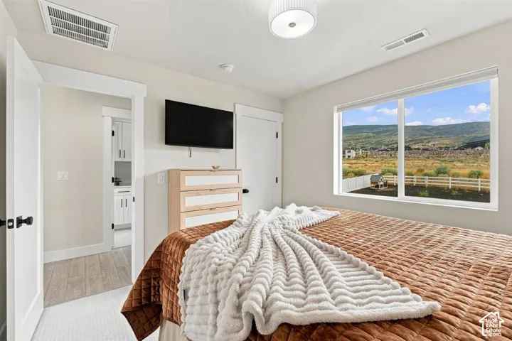 Light-filled room featuring large window, neutral colors and spacious closet