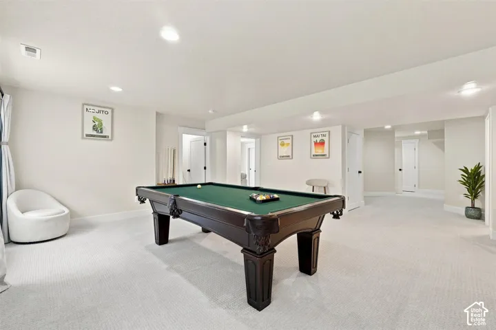 Spacious room with recessed lighting and neutral carpeting