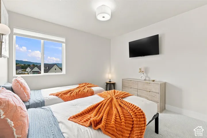 Comfortable bedroom features mountain view and large closet