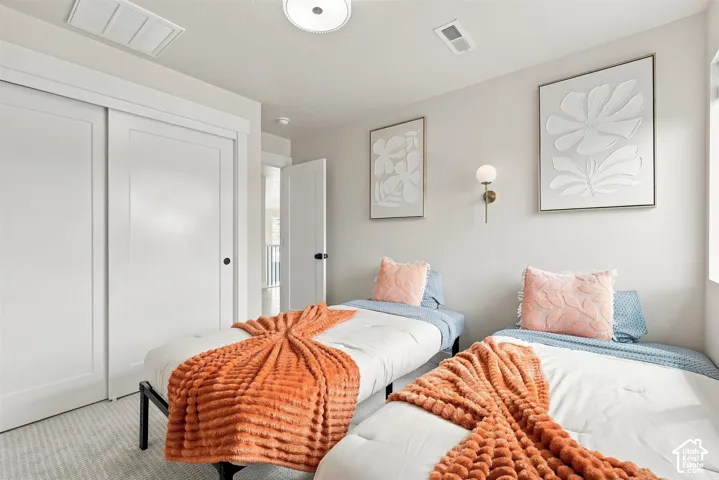 White sliding closet doors, overhead flush-mount lighting, and wall-mounted sconces