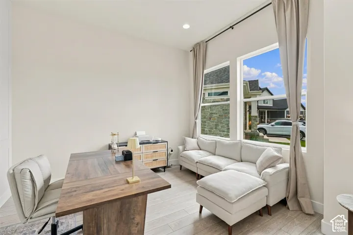 Currently used as an office, Also would work as formal living room. Soaring ceilings, large windows, recessed lighting, and light wood like-finish flooring