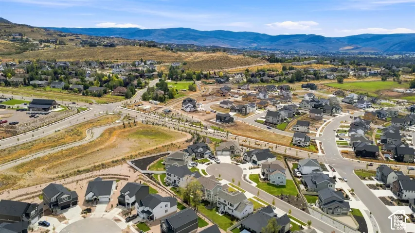 Expansive residential development featuring modern residences, paved roadways, and landscaped common areas