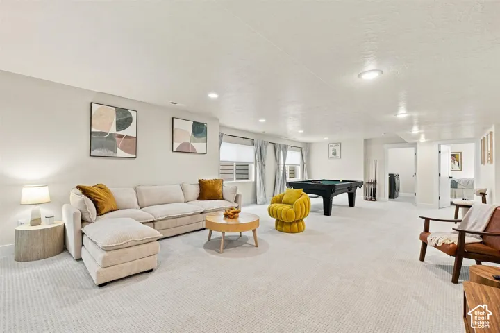 Recessed lighting illuminates a spacious carpeted area. Walk out basement door.